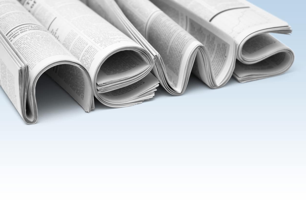 Stacks of modern newspapers, composed in form of word NEWS on gradient background. Concept of news and events of company